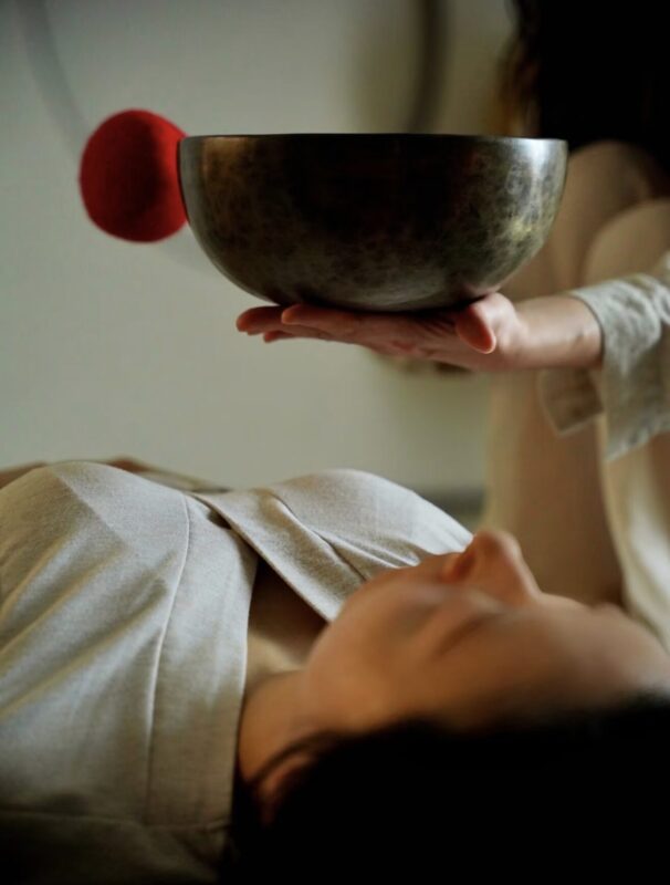 Close-up of hand-forged bronze singing bowl surface, showing hammered texture and patina