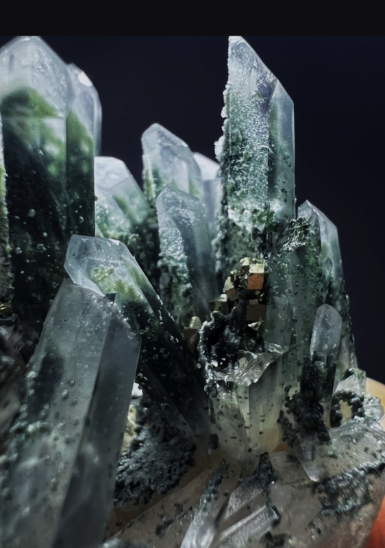 Green Phantom Crystal mineral specimen, clear quartz with green fuchsite phantom inclusions, natural stone on white background, minimalist crystal photography