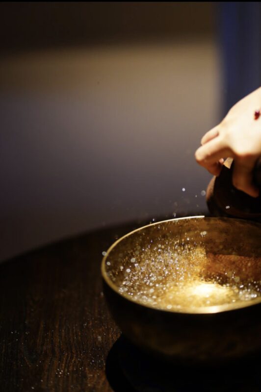 Singing bowl on a meditation cushion, morning light, calm and minimal interior aesthetic
