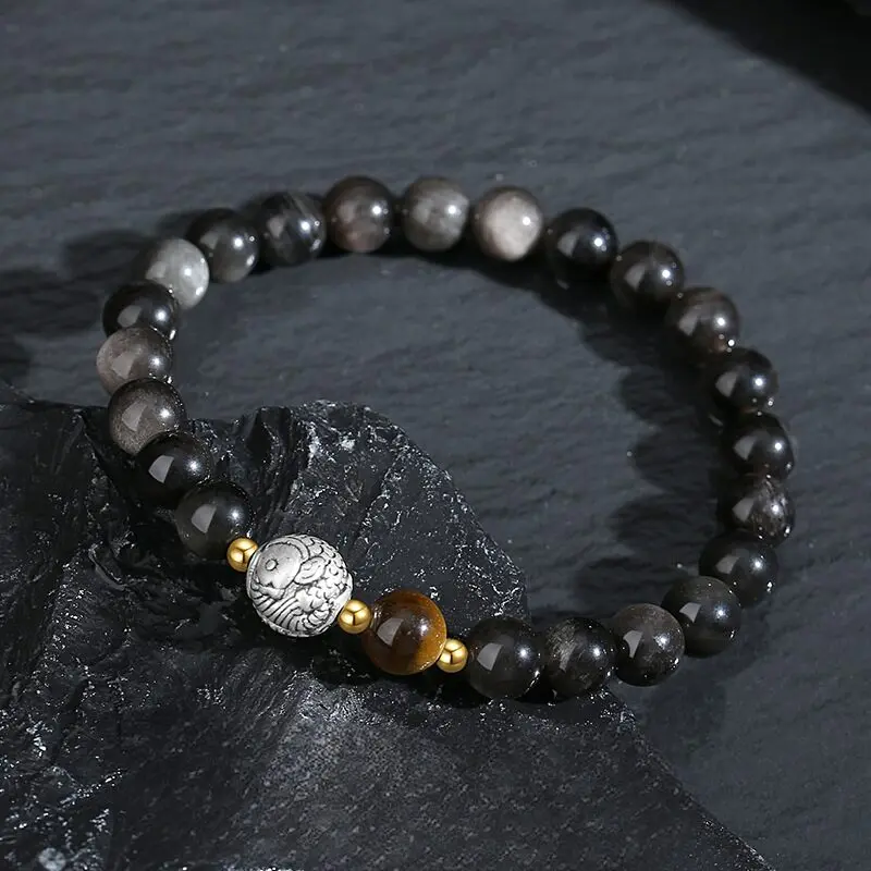 Black Obsidian volcanic glass bead detail, deep jet black polished surface, natural grey veining, 8mm round bead