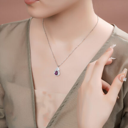 Symbolic gourd-shaped amethyst pendant with cubic zirconia