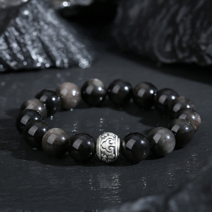 Black Obsidian auspicious cloud bracelet on wrist, everyday styling, dark quiet jewelry aesthetic, natural light photography