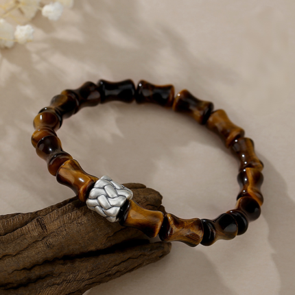 Close-up detail of bamboo-joint Tiger Eye beads showing chatoyant golden-brown luster, S925 silver rope knot ornament, antique finish silver detail