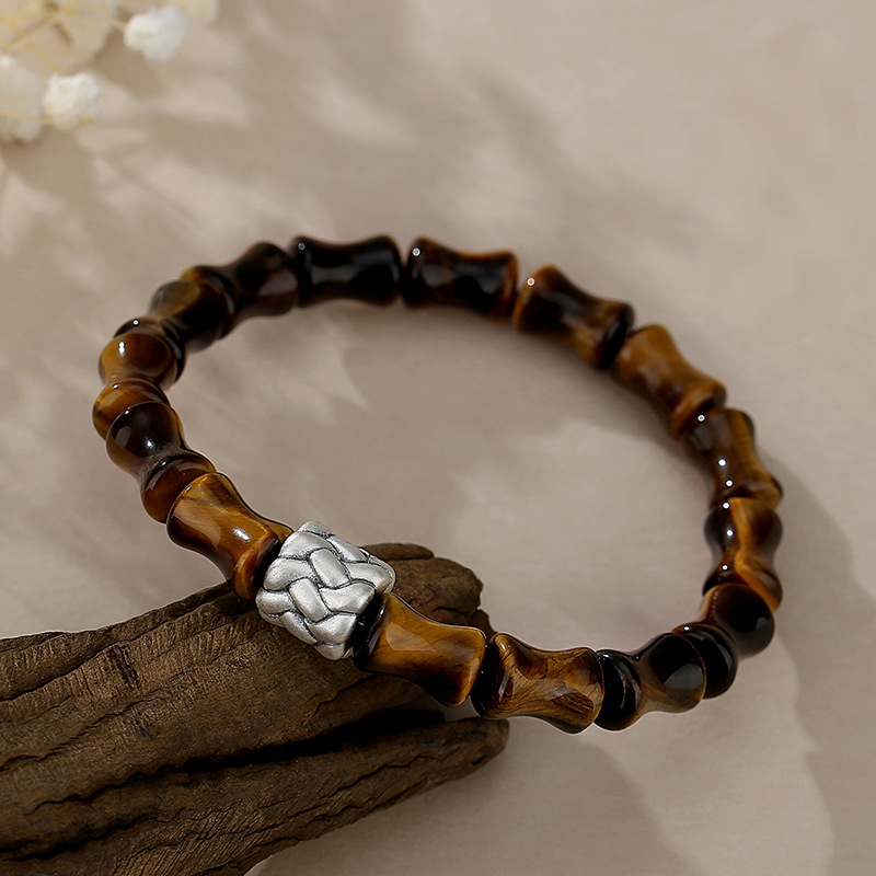 Close-up detail of bamboo-joint Tiger Eye beads showing chatoyant golden-brown luster, S925 silver rope knot ornament, antique finish silver detail