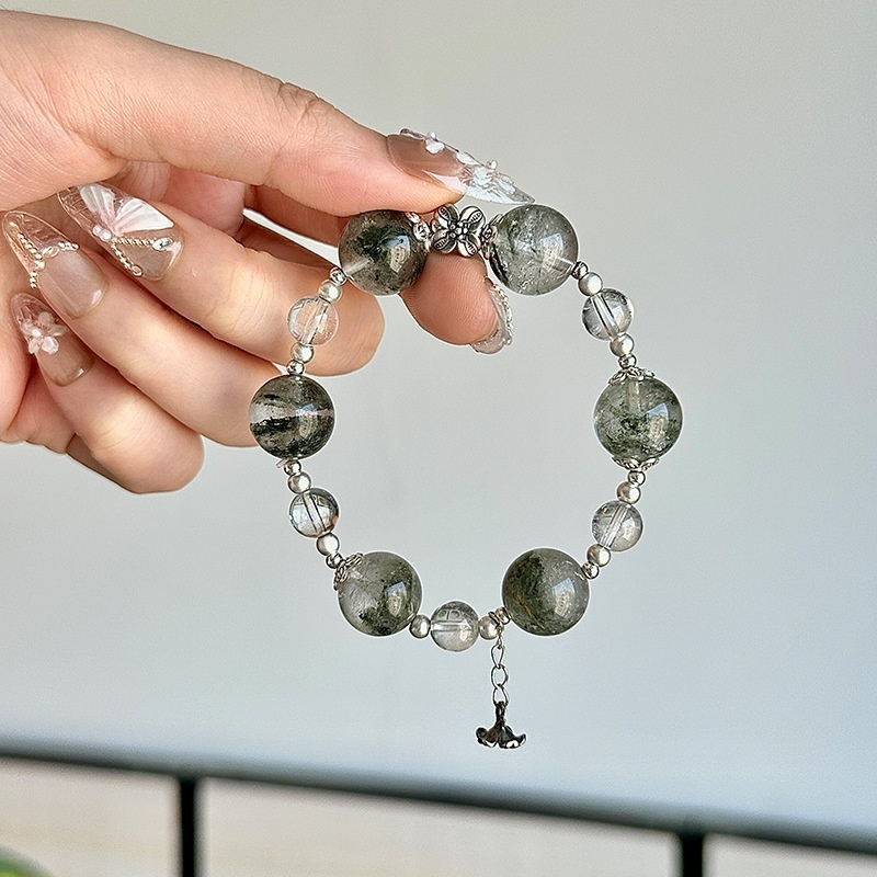 Green Phantom Crystal bracelet stacked with other crystal bracelets, layering styling, spiritual crystal jewelry collection