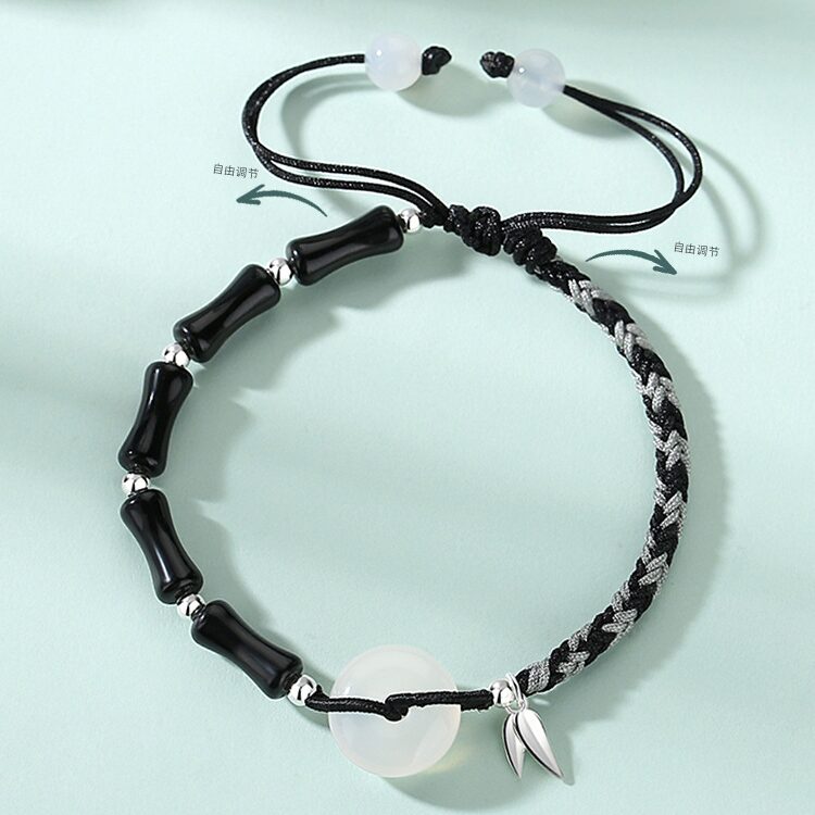 A matched pair of bamboo and peace circle braided bracelets — his in black obsidian bamboo joint beads, hers in white agate — both featuring a white agate peace circle with S925 silver bamboo leaf pendant, laid flat side by side on a white background.