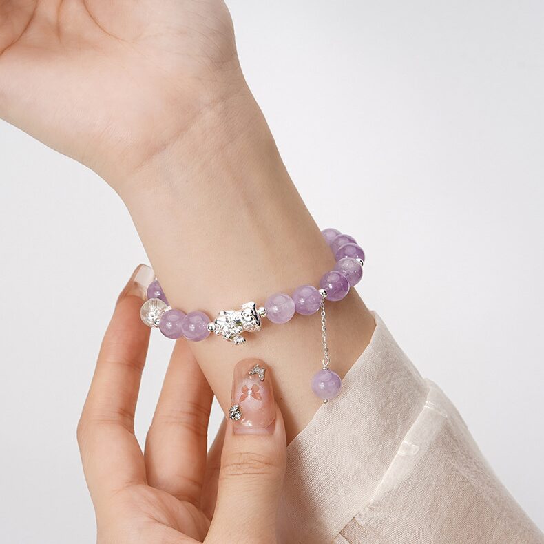 Amethyst and silver Pixiu bracelet worn on the wrist — spiritual prosperity jewelry in daily context.