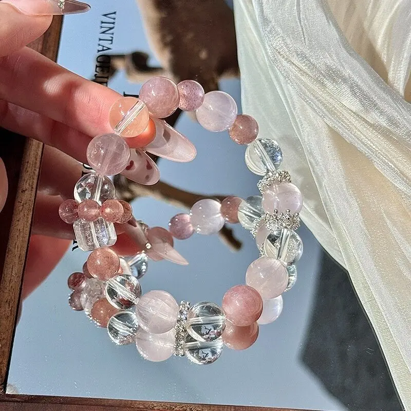 Silver-tone spacer beads with rhinestone detail, small sparkling accent beads between crystal sections, delicate silver spacer detail catching light
