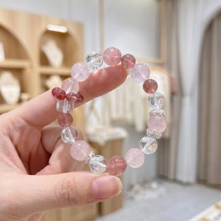 Silver-tone spacer beads with rhinestone detail, small sparkling accent beads between crystal sections, delicate silver spacer detail catching light