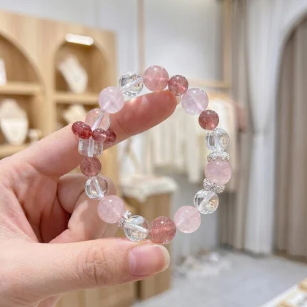 Silver-tone spacer beads with rhinestone detail, small sparkling accent beads between crystal sections, delicate silver spacer detail catching light