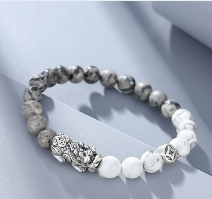 Close-up of the S925 silver Pixiu charm with intricate carved lucky symbols on the Pixiu Guardian bracelet.