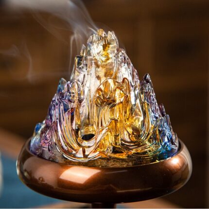 Translucent glazed琉璃mountain cap detail of Boshan incense burner, warm candlelight glowing through glaze from within, mountain peak detail, warm ambient light effect