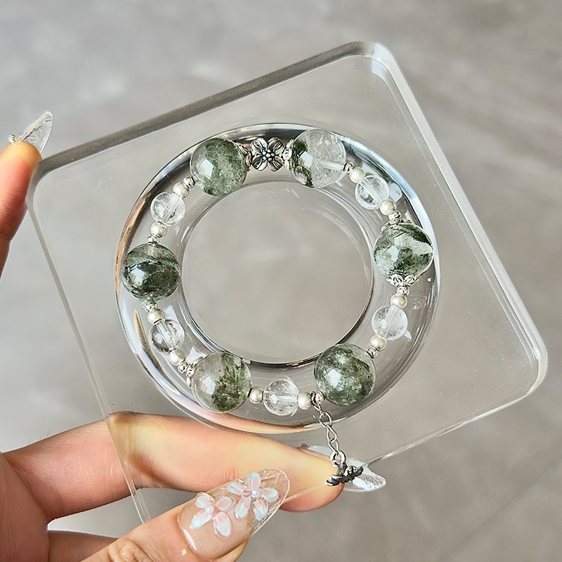 Green Phantom Crystal bracelet stacked with other crystal bracelets, layering styling, spiritual crystal jewelry collection