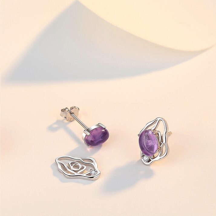 Pair of amethyst stud earrings in water-ripple open-work silver frame, faceted clear zircon accents, delicate feminine style, soft violet tones