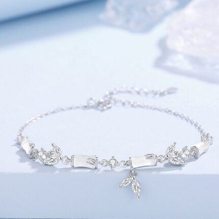 Flat-lay on white or neutral background showing the full chain with four bamboo joint beads, CZ accents, and mermaid tail charm clearly visible. Natural light to show the frosted agate surface.