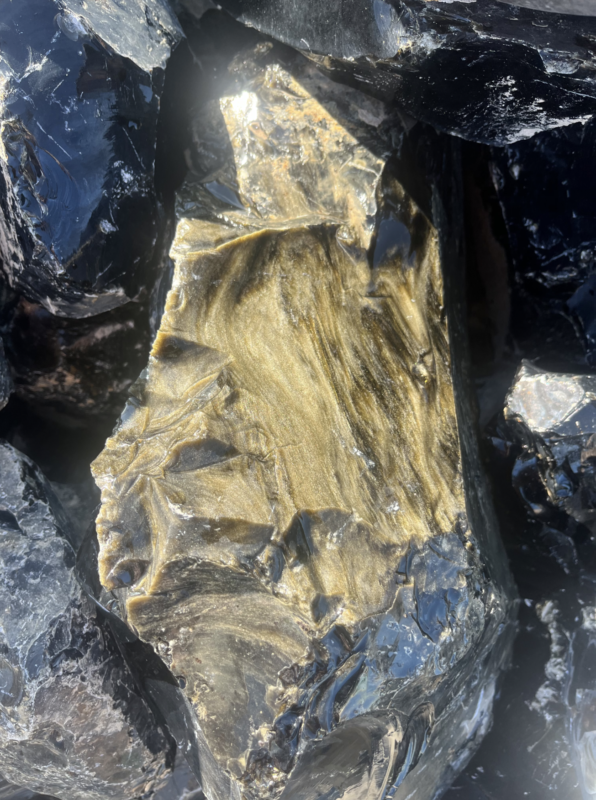 Golden sheen obsidian bracelet, polished volcanic glass with shimmering gold surface effect, dramatic minimalist design