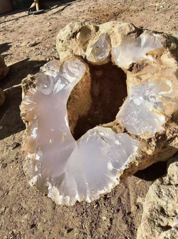 White agate tumbled stones on a light background, soft grey and cream tones, smooth polished surface